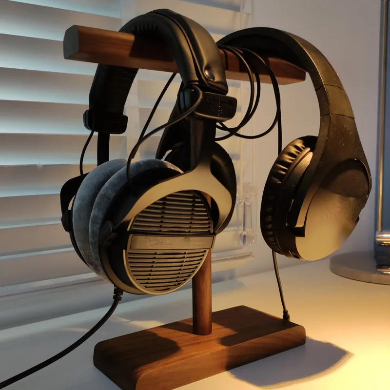 Wooden headphone stand showcasing headphones, an accessory to pair with a hockey table setup.